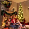 A family is reading a book by a fireplace and a Christmas tree. Voir les images du produit