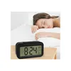 A woman sleeping in bed next to a digital alarm clock. Náhled obrázku produktu