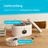 A white ultrasonic cleaner is shown on a wooden table, with a basket containing a watch and a pair of glasses and a bracelet next to it. Produktbild-Vorschau