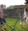 A family is playing soccer in the backyard. Produktbild-Vorschau