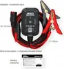 A NOCO GENIUS1 battery charger with its accessories, including jumper cables and an instruction manual, laid out on a white background. Podgląd zdjęcia produktu