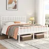 A white metal bed frame with a headboard and footboard, dressed with bedding and blankets, in a bedroom setting. Produktbild-Vorschau