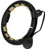 A black and gold massage hula hoop with a digital counter and a weighted ball. Náhled obrázku produktu