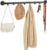 A black metal coat rack with various items hanging on it, including a handbag, a hat, a jacket, keys, and a dog leash. Produktbild-Vorschau