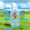 A blue walkie-talkie with a cartoon character on its screen, set against a backdrop of green grass and mountains under a blue sky. Produktbild-Vorschau