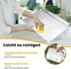 A person is washing a baking sheet under a faucet, with text overlays describing its features. Produktbild-Vorschau