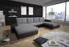 A modern living room with a large sectional sofa, a large window overlooking a city skyline, and decorative elements. Náhled obrázku produktu