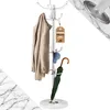 A white metal coat rack with a marble base, displaying a beige coat, a blue hat, and a green umbrella. Anteprima dell’immagine prodotto