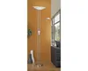 A floor lamp with two lights stands in a room with an orange wall and a window in the background. Produktbild-Vorschau