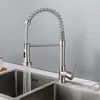 A kitchen faucet with water running into a double sink. Podgląd zdjęcia produktu