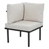 A corner chair with beige cushions and a black metal frame, isolated on a white background. Anteprima dell’immagine prodotto