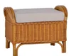 A rattan ottoman with a beige cushion on a white background.