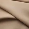 A close-up view of folded taupe fabric, likely curtains. Produktbild-Vorschau