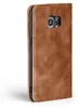 A close-up side view of a brown leather flip case for a smartphone, showing the camera cutout. Produktbild-Vorschau