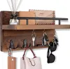 A wooden key holder with several hooks and a shelf, displaying various items like keys, a wallet, sunglasses, a purse, and a diffuser. Produktbild-Vorschau