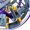 A close-up view of a complex maze toy with intricate pathways and mechanisms. Produktbild-Vorschau