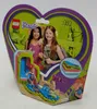 The image shows the front of a LEGO Friends Mia's Summer Heart Box playset packaging. The packaging is heart-shaped and features images of the playset, two girls, and various LEGO Friends branding. Produktbild-Vorschau