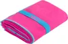 A folded pink microfiber towel with a blue elastic band around it, which has the word "NILS" printed on it. Produktbild-Vorschau
