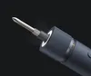 Close-up of the tip of a cordless screwdriver with a bit inserted, against a dark background. Voir les images du produit