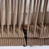 A close-up view of beige ropes on an outdoor chair. Produktbild-Vorschau