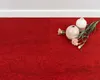 Two vases and flowers are placed on a red carpet next to a white wall. Produktbild-Vorschau