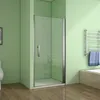A modern bathroom with a glass shower enclosure, a toilet, and a towel rack. Produktbild-Vorschau