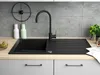 A modern kitchen sink area with a black granite sink, black faucet, and a concrete tile backsplash. Náhľad obrázku produktu