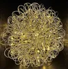A spherical decorative light fixture made of intertwined silver wire with embedded yellow LED lights. Produktbild-Vorschau