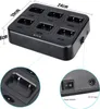 A multi-way charger for walkie-talkies, with close-up views of the charging slots and the power switch and input port. Produktbild-Vorschau