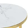 A close-up view of the edge of a round table with a white marble-look top and a gold metal rim. Produktbild-Vorschau