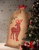 A large burlap Christmas sack with a red plaid reindeer design is placed next to a decorated Christmas tree. Anteprima dell’immagine prodotto
