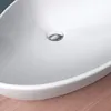 A close-up view of a white ceramic sink with a chrome drain. Produktbild-Vorschau