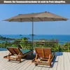 A double patio umbrella shades two lounge chairs on a wooden deck overlooking the ocean. Náhled obrázku produktu