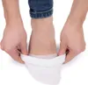 A person is putting on a white sock on their foot. Podgląd zdjęcia produktu