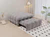 A modern living room with a gray sofa bed and a plant. Produktbild-Vorschau
