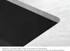 A close-up view of the edge of a black sink with a marble countertop. Podgląd zdjęcia produktu