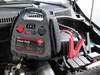 A jump starter power pack is connected to a car battery in an engine bay. Anteprima dell’immagine prodotto