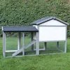 A wooden and wire chicken coop with a ramp, set on green grass with a hedge in the background. Produktbild-Vorschau