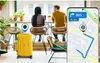Two people sitting at a counter with a yellow suitcase and a smartphone displaying a map. Anteprima dell’immagine prodotto
