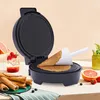 An electric waffle maker for ice cream cones is shown on a table with fruit and finished ice cream cones. Náhled obrázku produktu