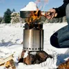 A person is using a Solo Stove campfire stove in a snowy environment to melt snow in a pot. Produktbild-Vorschau