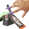 A hand is using a fingerboard on a miniature skatepark track with an arcade game element. Produktbild-Vorschau