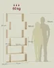 A diagram showing a bookshelf with dimensions and two human silhouettes for scale, along with weight capacity information. Náhled obrázku produktu
