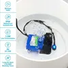 A small blue and black water pump submerged in white liquid, with bubbles rising. Produktbild-Vorschau