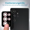 A finger is shown applying a camera lens protector to a smartphone. Produktbild-Vorschau