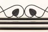 A close-up of a black metal bench with decorative leaf motifs. Produktbild-Vorschau