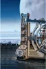 A close-up of a wooden 3D puzzle marble run, set against a backdrop of a large moon and a hazy landscape. Podgląd zdjęcia produktu