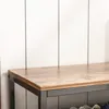 Close-up of a wooden shelf with a metal frame, against a white paneled wall. Podgląd zdjęcia produktu