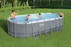 A family is enjoying an oval-shaped above-ground swimming pool in a grassy backyard on a sunny day. Anteprima dell’immagine prodotto