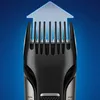 Close-up of a beard trimmer head with an upward arrow graphic indicating growth or length. Podgląd zdjęcia produktu